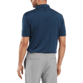 A man is seen from the back wearing a FootJoy Mens Micro Feeder Stripe Lisle Polo in Navy/Tonal and light gray pants, with his left arm slightly bent.