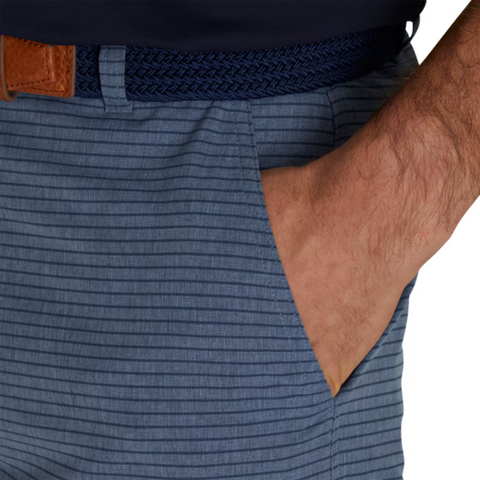 A close-up shows a hand in the pocket of FootJoy Mens Performance Lightweight Short, blue striped with a braided navy belt and brown leather accent, highlighting the moisture-wicking comfort from FootJoy.