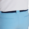 Wearing FootJoy Mens Performance Lightweight Short in light blue stripes with two back pockets, a dark blue braided belt, and a tucked-in white shirt provides breathable, moisture-wicking comfort from FootJoy on the course.