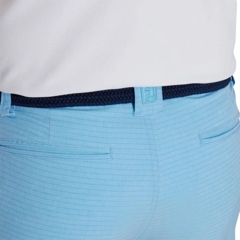 Wearing FootJoy Mens Performance Lightweight Short in light blue stripes with two back pockets, a dark blue braided belt, and a tucked-in white shirt provides breathable, moisture-wicking comfort from FootJoy on the course.