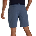 A man, seen from the back with arms relaxed, wears blue pinstriped FootJoy Men’s Performance Lightweight Shorts and a dark belt.