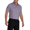 A man wearing a FootJoy Men's Scallop Shell Foulard Lisle Polo, tucked into black pants with a black belt, stands against a white background.