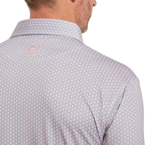 A close-up of the back of a person wearing a pink FootJoy Men's Scallop Shell Foulard Lisle Polo with a geometric pattern, moisture-wicking fabric, and a small FJ logo below the collar. The person’s head is turned slightly away from the camera.