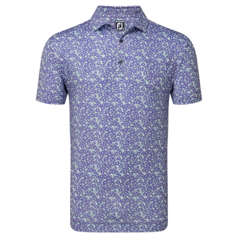 The FootJoy Primrose Print Lisle Mens Polo is a short-sleeved polo with a purple and light blue floral print, moisture-wicking fabric, a collar, three-button placket, and an FJ logo on the inner collar.