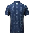 Back view of the FootJoy 19th Hole Polo in navy blue, featuring a playful golf-themed print across the entire shirt. The FootJoy logo is visible below the collar, adding a branded touch.