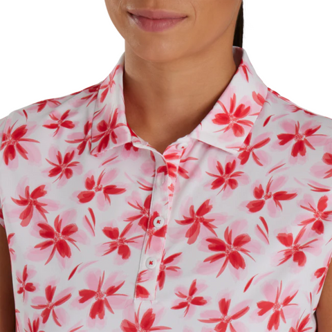 Close-up of a sleeveless FootJoy golf shirt with a red and pink floral pattern on a white background. The image highlights the shirt's buttoned placket and collar, showcasing the vibrant floral design perfect for a summer golf outfit.