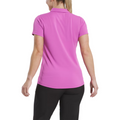 A person stands with their back to the camera, wearing a FootJoy Women's Jacquard Short Sleeve Shirt in Berry and black pants, set against a plain white background.