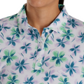 A person wearing a FootJoy Women's Long Sleeved Floral Shirt in Lavender/Mint/Teal. Only the lower face, neck, and upper torso are visible.