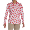 A person is wearing a FootJoy Women's Long Sleeved Floral Shirt, featuring a collared white design with a red pattern, paired with beige pants. The face is not visible.