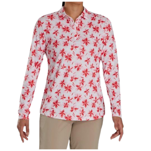 A person is wearing a FootJoy Women's Long Sleeved Floral Shirt, featuring a collared white design with a red pattern, paired with beige pants. The face is not visible.