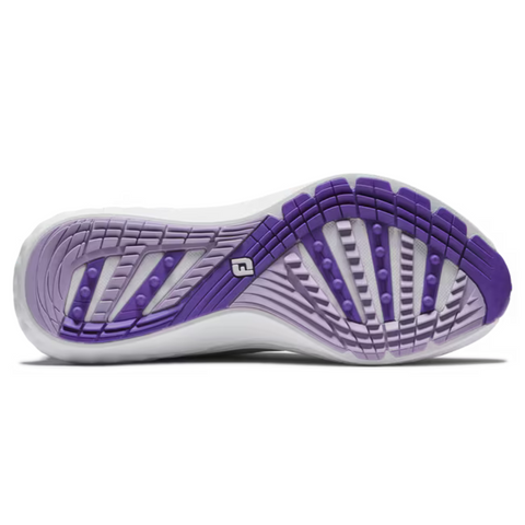 The image displays the outsole of the FootJoy Women's Quantum Golf Shoes in Grey/White/Purple, featuring textured grip patterns, a central logo, and wave-like grooves with raised rubber sections for enhanced traction.