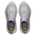 A top-down view of FootJoy Women's Quantum Golf Shoes in grey, white, and purple: slip-on, spikeless, with gray lining, yellow-purple insoles featuring the FootJoy logo, the word “improve,” and OrthoLite FitBed cushioning.