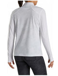 A woman with her hair in a ponytail is seen from behind wearing the FootJoy Women's Sun Protection Long Sleeve Shirt in white.