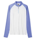 The FootJoy Women's Sun Protection Shirt in White/Violet features long sleeves, a zip-neck, and offers sun protection. It is displayed with a white body and light purple sleeves and collar against a plain white background.