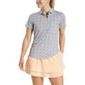 A woman in a FootJoy Womens Floral Print Short Sleeve Shirt stands smiling, one hand relaxed at her side.