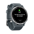 A grey Garmin Approach S44 GPS Watch by Garmin shows Joel’s message—“Tee time at 12:30. Are you coming?”—on its round display, seamlessly combining smart notifications with advanced golf technology.