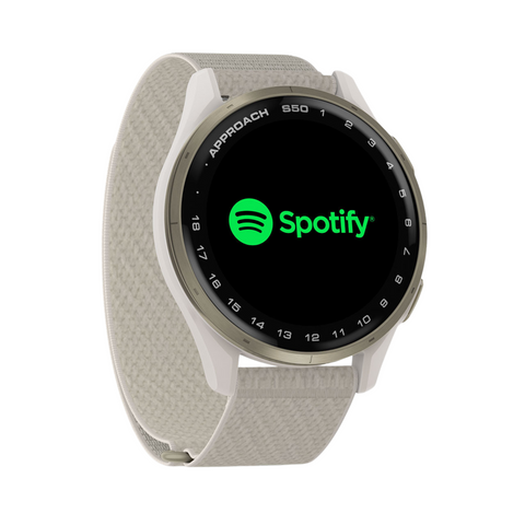 A white Garmin Approach S50 GPS Watch with a woven fabric band shows the Spotify logo on its round screen. The bezel features “APPROACH S50” along with various icons and numbers.