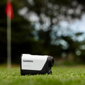 Garmin Approach Z10 golf laser rangefinder beside a putting green