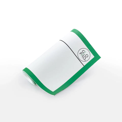 The GloPro Fire Fly Portable Stroke Reader by GloPro is a rolled-up white alignment sheet with a green border and a pro glo logo inside a rounded square in the top right corner, shown on a white surface.