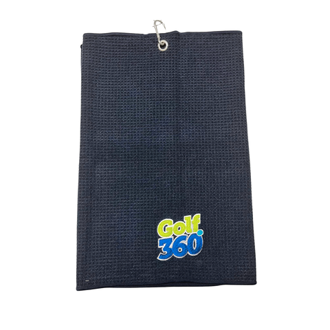 The Sporte Leisure Golf 360 Waffle Golf Towel is black with a textured pattern, metal grommet and hook, and features a blue, green, and white embroidered Golf 360 logo at the bottom. Fast-drying, it’s stylish and functional.