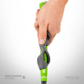 A right hand holds a green club with the gray Golf-Grip Training Aid by Golf-Grip, showing correct hand positioning. Text reads RIGHT-HANDED SHOWN; green golf club not included.
