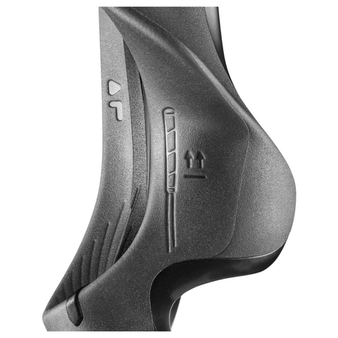 Close-up of the Golf-Grip Training Aid by Golf-Grip, featuring a black, curved textured plastic design with engraved arrows and directional symbols on its surface, set against a plain white background.
