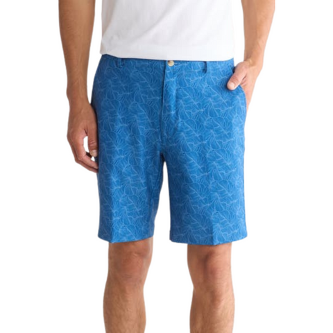 Greg Norman Tonal Palm Leaves shorts in maritime blue with a subtle palm leaf pattern, worn by a model, shown in a front view with hands in pockets.