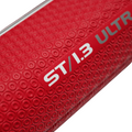Close-up of the red textured surface and circular patterns on the JumboMax ST/1.3 Jumbo Putter Grip in Red/Black, featuring bold white and silver branding—spotlighting its non-tapered design by JumboMax.