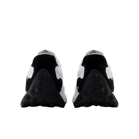 The New Balance 327 Womens Golf Shoes in white and black are shown from the back, highlighting the heels and textured black soles with circular patterns against a white background.