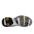 The image displays the sole of the New Balance Brighton V2 Mens Golf Shoes in White/Grey, featuring six yellow cleats and textured gray and black rubber patterns for advanced traction.
