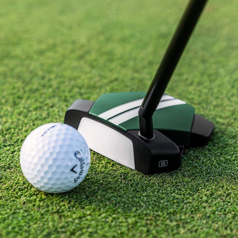 Odyssey TRTL Slant Neck putter behind a ball on the green, showing the face and slant hosel