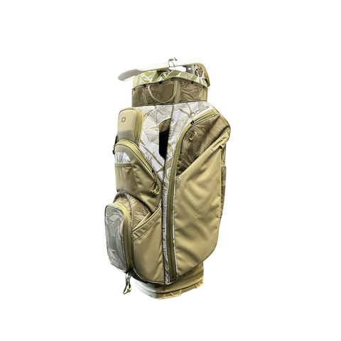 The Ogio 2026 Silencer Cart Bag | Oasis features a beige and olive green leaf-patterned design, multiple pockets, a side handle, and advanced club protection, shown on a white background.