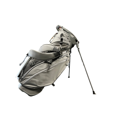 The Ogio 2026 Silencer Hybrid Bag in Volcanic features multiple zippered pockets, a padded shoulder strap, two stand legs, and advanced club security, shown isolated on a white background.
