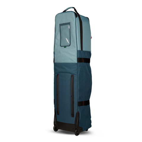 The Ogio Alpha Mid Travel Cover by Ogio is a tall, blue, rectangular rolling bag with two wheels, top handle, clear ID window, multiple zippers, and black straps—ideal for protecting golf clubs while traveling.