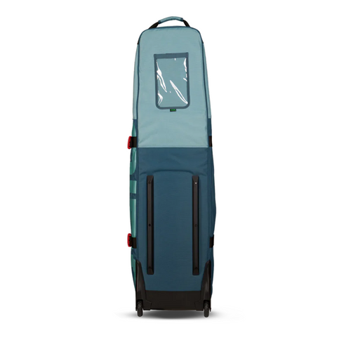 The Ogio Alpha Mid Travel Cover by Ogio is a tall blue golf travel bag with a windowed top pocket, black wheels, and side handles, designed to transport large items securely while protecting your clubs.