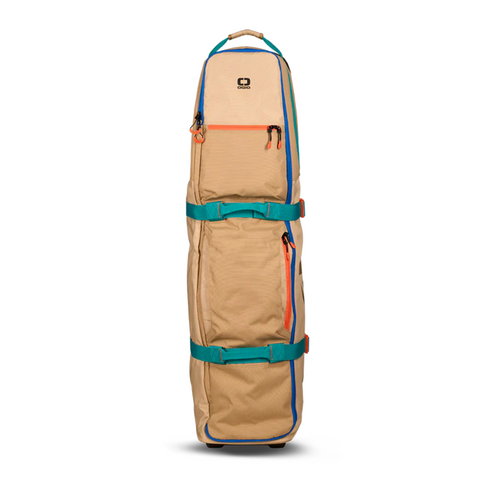 The Ogio Alpha Mid Travel Cover by Ogio is a tan golf travel cover with teal and orange accents, two adjustable straps, a top handle, front zippers, and wheels for easy transport. It stands upright against a white background for club protection.