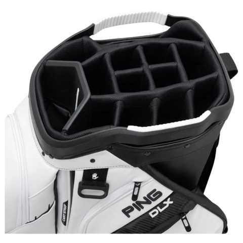 A close-up of the PING 2026 DLX 244 Cart Golf Bag by Ping in white, showcasing a 15-way top for club organization and several side zippered pockets.