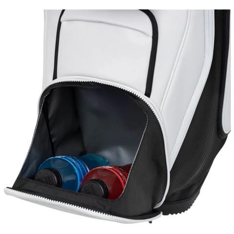 A close-up of the open zippered pocket on the Ping 2026 DLX 244 Cart Golf Bag in white shows two sports drink bottles, one red and one blue, stored inside.