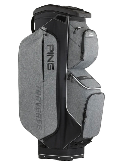 A PING Traverse golf bag in heather gray and black, featuring multiple zippered compartments and the PING logo printed on the bag