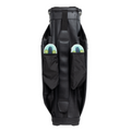 The Ping DLX 244 Cart Golf Bag stands upright in black, showcasing its modern, sleek design and smooth texture. Two side pockets each hold a colorful disc golf disc, partly visible.