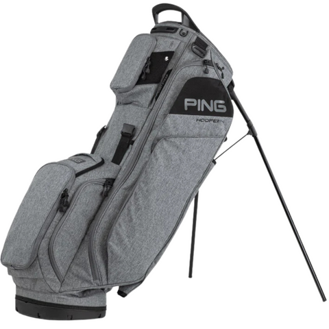 A Ping Hoofer 14 Stand Bag in gray, featuring multiple zippered pockets and a 14-way top divider, stands upright on its extended legs.