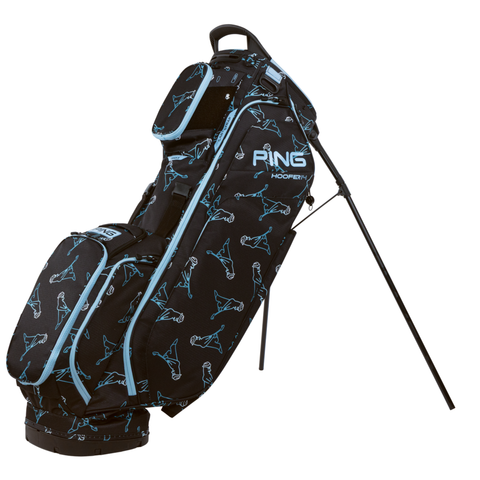 The PING Hoofer 14 Stand Bag in Mr PING Black/Blue by Ping features a black design with light blue accents, golfer outlines, a 14-way top, and stands upright on extended legs.