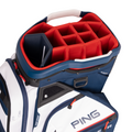 A close-up of the PING Pioneer 244 Golf Cart Bag by Ping shows red interior dividers, navy and white exterior, and the Ping logo. This cart bag offers multiple compartments—perfect for New Zealand golfers seeking premium storage.