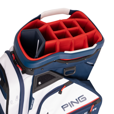 A close-up of the PING Pioneer 244 Golf Cart Bag by Ping shows red interior dividers, navy and white exterior, and the Ping logo. This cart bag offers multiple compartments—perfect for New Zealand golfers seeking premium storage.