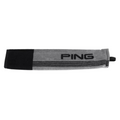 A gray and black rectangular PING Tri-Fold Golf Towel by Ping, featuring PING lettering and a small black loop for easy attachment, ideal for cleaning clubs, shown laid flat on a white background.