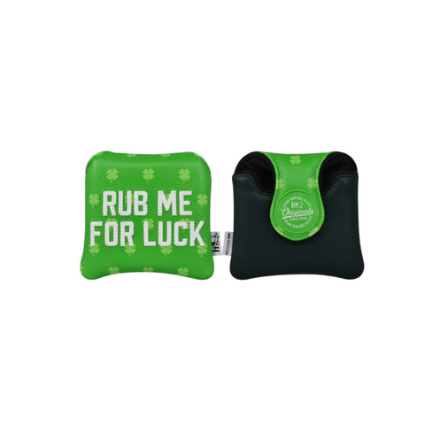 Two small green and black PRG pouches. One is the PRG Originals 2025 Luck of the Irish Mallet Putter Headcover, with “RUB ME FOR LUCK” and shamrocks; the other has a round label, flap opening, and both have a textured surface.