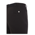 Close-up of the back of ProQuip Winter Tech Womens Pants, featuring a rear pocket with a small round metallic ProQuip logo above it, plus part of the waistband and belt loop.