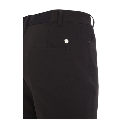Close-up of the back of ProQuip Winter Tech Womens Pants, featuring a rear pocket with a small round metallic ProQuip logo above it, plus part of the waistband and belt loop.