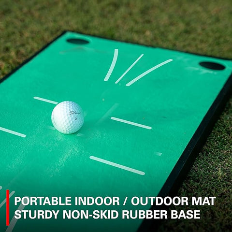A white golf ball sits on the green Rukket Pathfinder Impact Swing Trainer by Rukket, featuring a sturdy non-skid rubber base and printed markings for indoor or outdoor golf training.