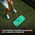A golfer practices with the Rukket Pathfinder Impact Swing Trainer by Rukket on a green mat with white lines, aiming to hit the ball longer and straighter. Red tees rest nearby on the grass. Text: Two powerful golf training aids in one.